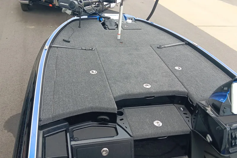 Slide: The Image of 2025 Triton 20XP boat deck with storage compartments and fishing equipment. - 10