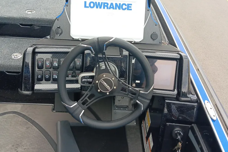 Slide: The Image of 2025 Triton 20XP boat dashboard with steering wheel and Lowrance electronics. - 12