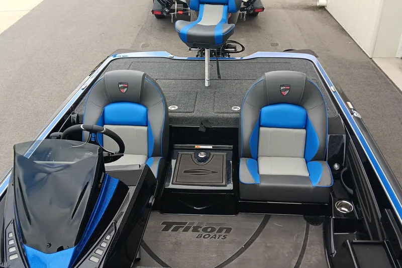 Slide: The Image of 2025 Triton 20XP boat interior with blue and gray seating, steering console, and branding. - 14