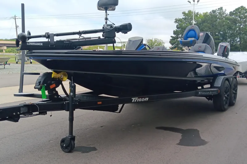 Slide: The Image of 2025 Triton 20XP boat on trailer, featuring Lowrance equipment, parked outdoors. - 5