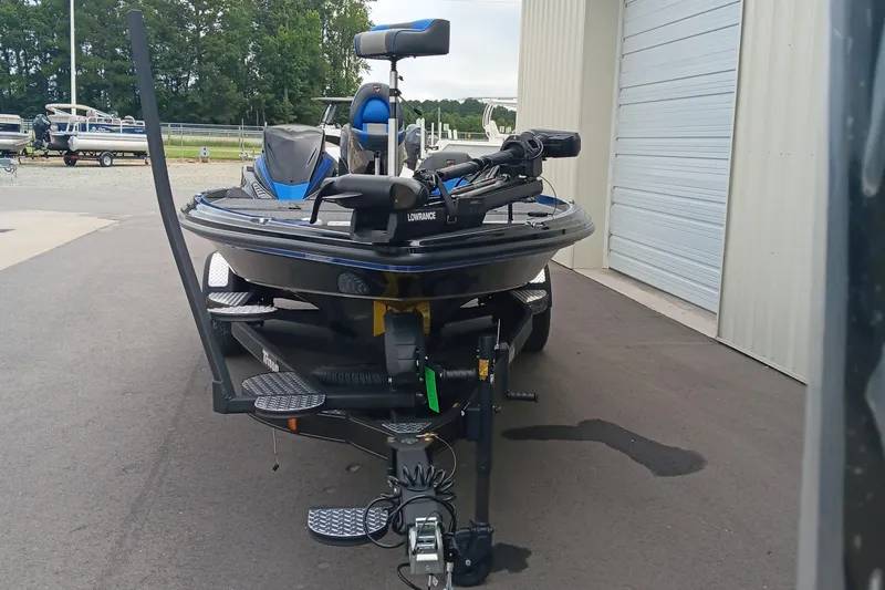 Slide: The Image of 2025 Triton 20XP boat with advanced equipment, parked outside a storage facility. - 6