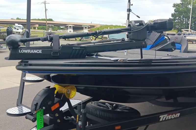 Slide: The Image of 2025 Triton 20XP boat with Lowrance Ghost trolling motor on trailer. - 7