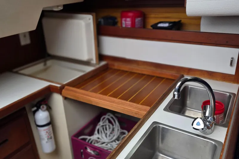 Slide: The Image of Interior of 1987 Catalina 30 MkII sailboat galley with sink, counter, and storage. - 10