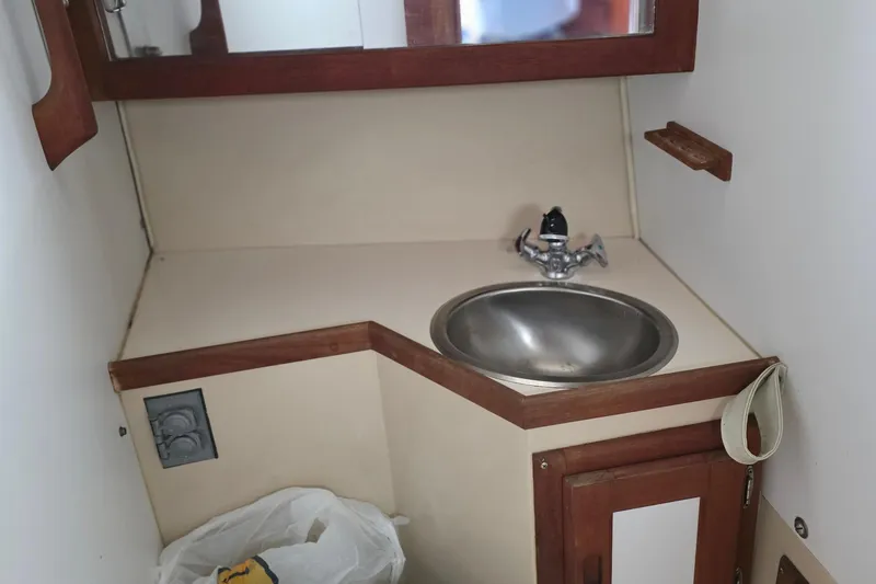 Slide: The Image of Compact bathroom sink area in a 1987 Catalina 30 MkII sailboat. - 14
