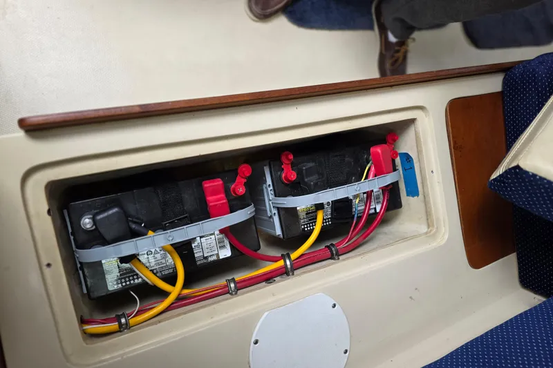 Slide: The Image of Battery compartment of a 1987 Catalina 30 MkII sailboat, showing wiring and connections. - 16