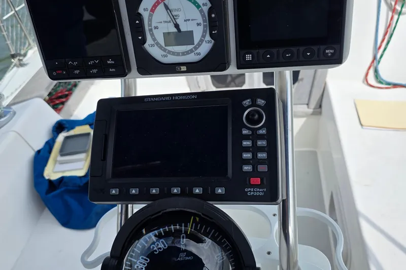 Slide: The Image of Cockpit instruments of a 1987 Catalina 30 MkII sailboat, featuring navigation and wind gauges. - 19