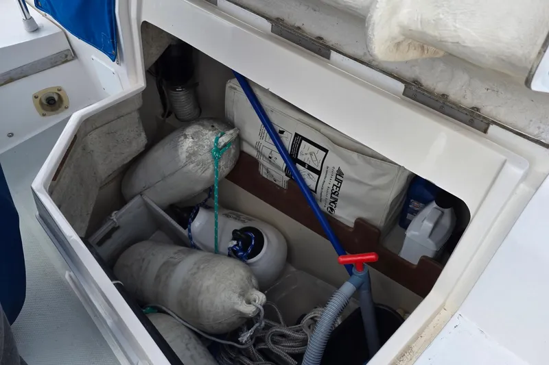 Slide: The Image of Storage compartment on a 1987 Catalina 30 MkII sailboat with fenders and cleaning supplies. - 20