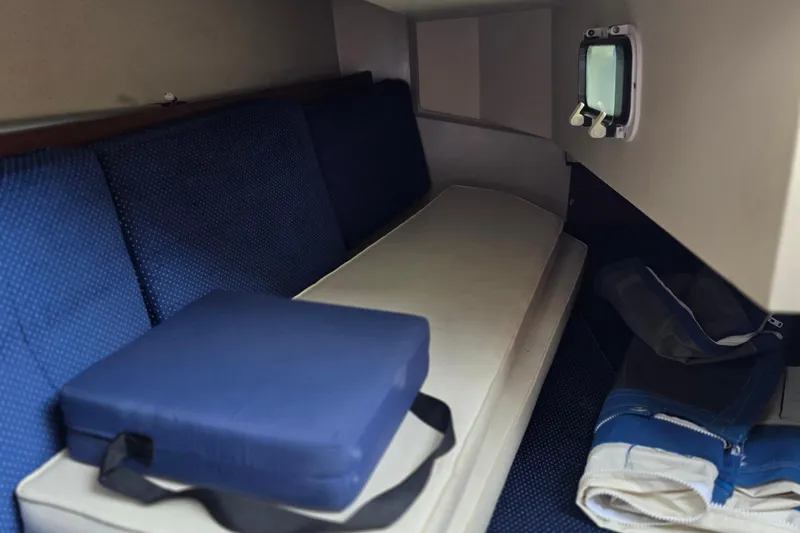Slide: The Image of Interior cabin of 1987 Catalina 30 MkII sailboat with blue cushions and storage. - 4