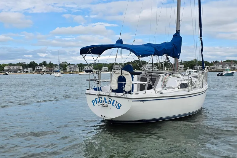 Slide: The Image of 1987 Catalina 30 MkII sailboat "Pegasus" anchored in a scenic harbor. - 6
