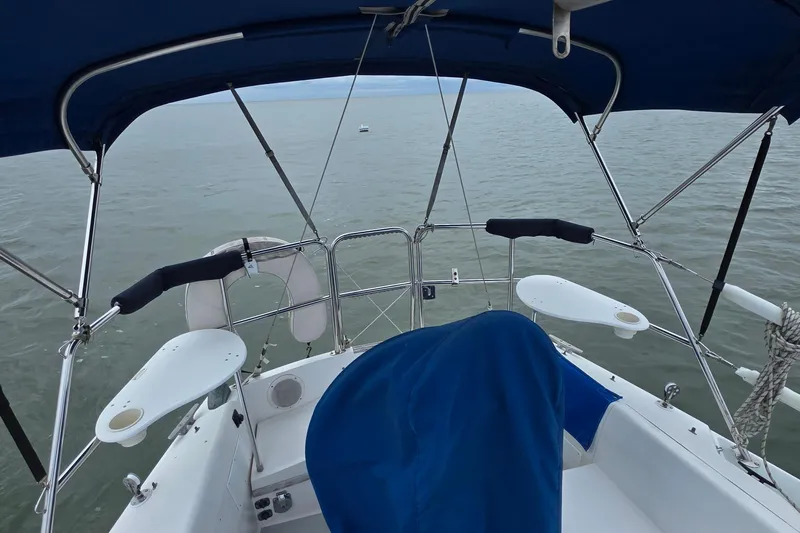 Slide: The Image of Cockpit view of 1987 Catalina 30 MkII sailboat with blue canopy on calm water. - 9