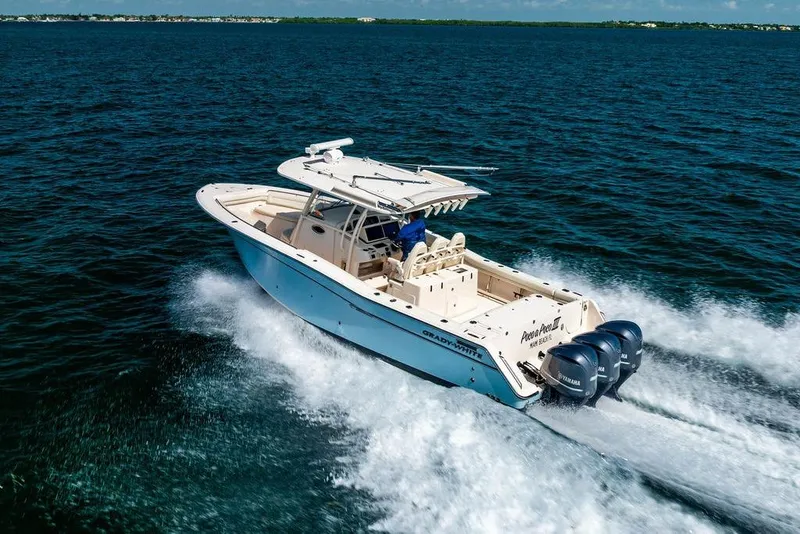 Slide: The Image of 2016 Grady-White Canyon 336 boat cruising on open water, rear view. - 1