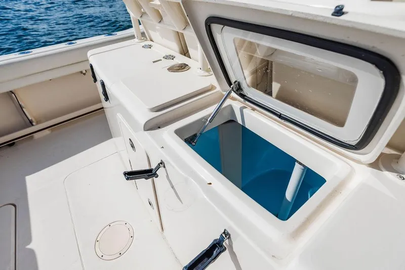 Slide: The Image of 2016 Grady-White Canyon 336 boat interior with open storage compartment. - 12