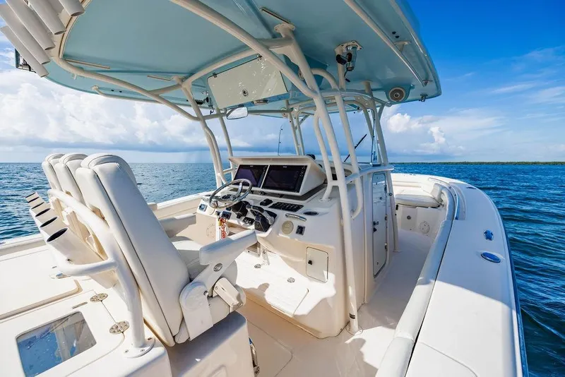 Slide: The Image of 2016 Grady-White Canyon 336 boat interior with helm, ocean view, and clear sky. - 13