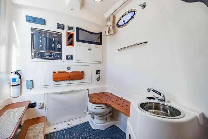 Slide: The Image of 2016 Grady-White Canyon 336 boat interior with control panel, sink, and toilet. - 19