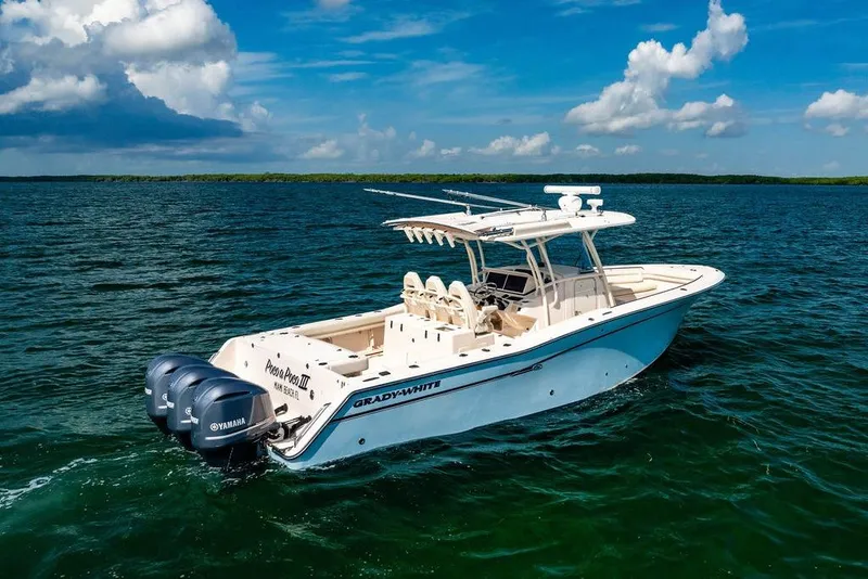 Slide: The Image of 2016 Grady-White Canyon 336 boat on open water under blue sky. - 3