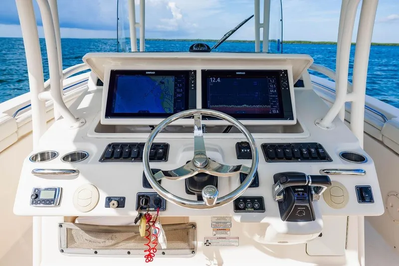 Slide: The Image of 2016 Grady-White Canyon 336 boat dashboard with navigation screens and controls. - 7