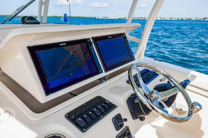 Slide: The Image of 2016 Grady-White Canyon 336 helm with dual Simrad displays on open water. - 9