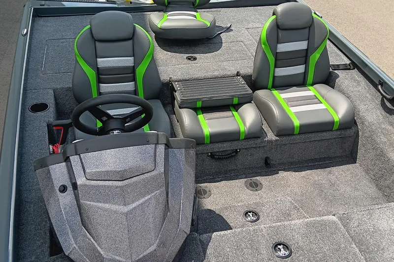 Slide: The Image of 2025 Ranger RT188P boat interior with gray and green seats, steering wheel, and carpeted flooring. - 12