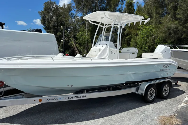 The Image of 2025 Glasstream 240 CCX boat on trailer, parked outdoors with trees in background. - 0