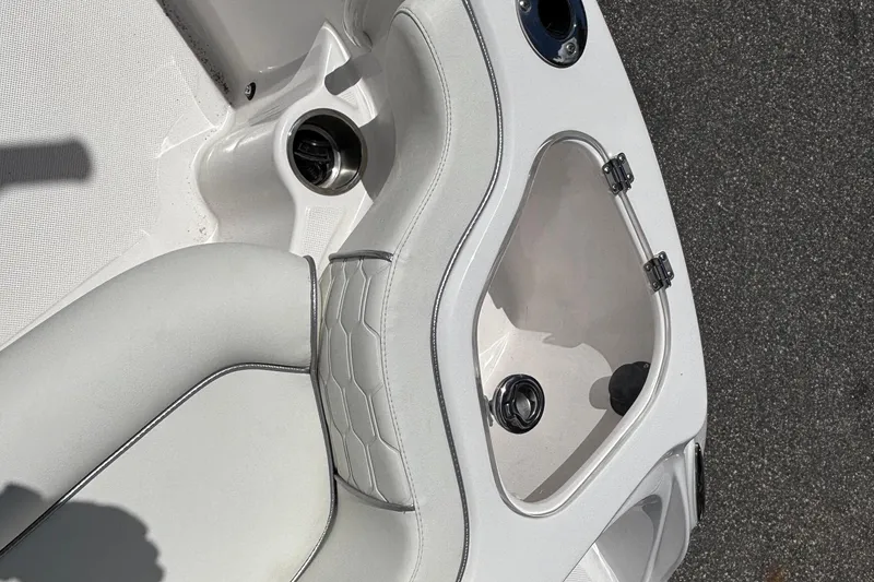 Slide: The Image of 2025 Glasstream 240 CCX boat interior with white seating and storage compartment. - 13