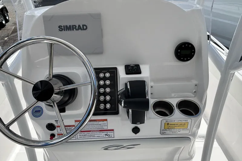 Slide: The Image of Control panel of 2025 Glasstream 240 CCX boat with steering wheel and Simrad display. - 15