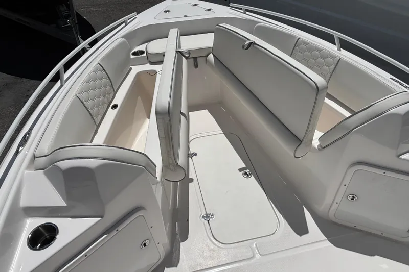 Slide: The Image of 2025 Glasstream 240 CCX boat interior with white cushioned seating and storage compartments. - 5