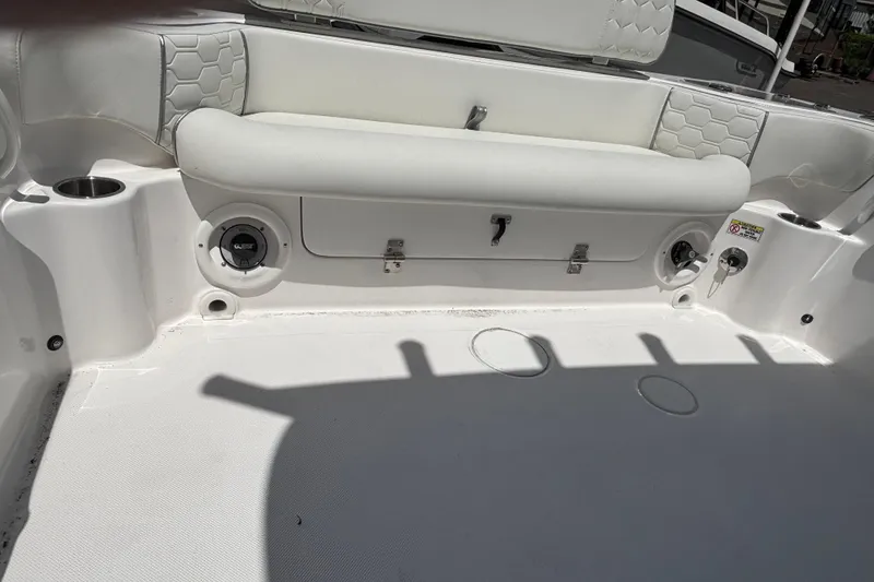 Slide: The Image of 2025 Glasstream 240 CCX boat interior with cushioned seating and cup holders. - 6