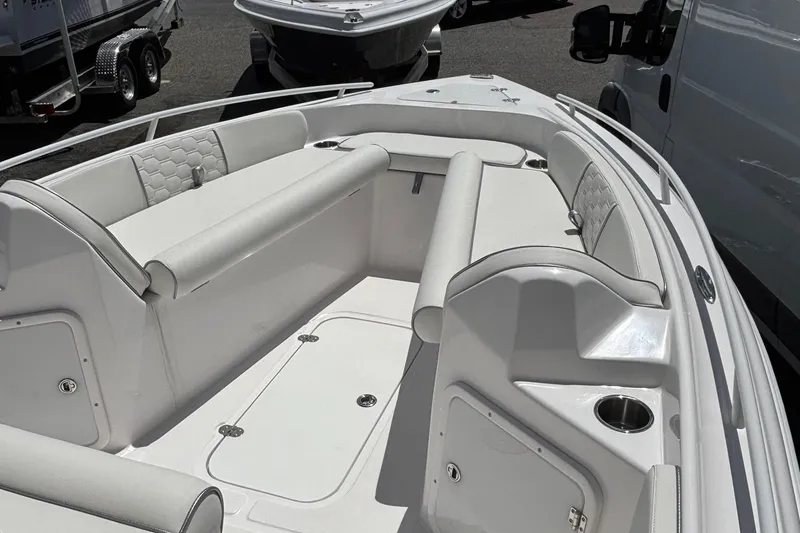 Slide: The Image of 2025 Glasstream 240 CCX boat interior with white seating and storage compartments. - 8