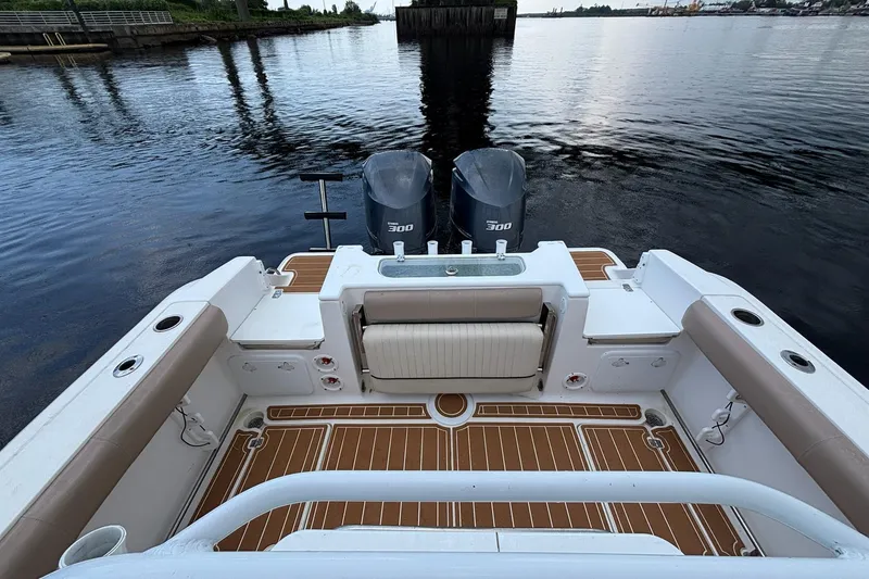 Slide: The Image of 2016 Sea Fox 286 boat with dual engines, spacious deck, and comfortable seating. - 12