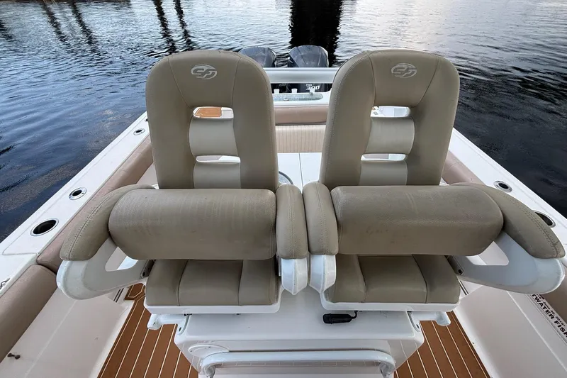 Slide: The Image of Dual captain's chairs on 2016 Sea Fox 286 boat, overlooking calm water. - 15