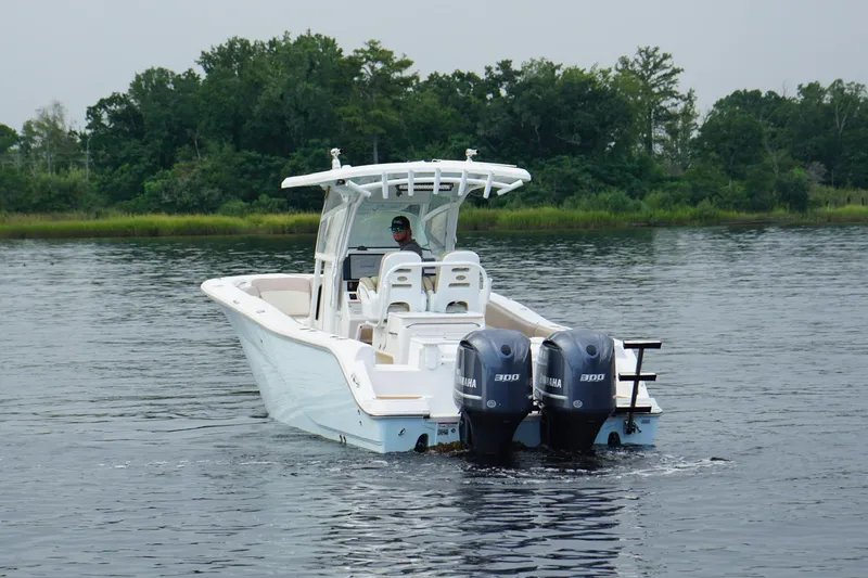 Slide: The Image of 2016 Sea Fox 286 boat with dual Yamaha engines on a calm lake. - 21