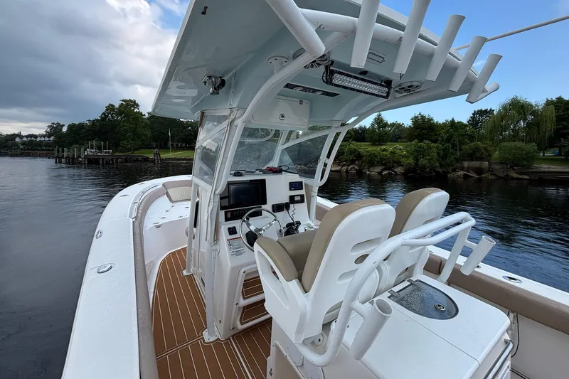 Slide: The Image of 2016 Sea Fox 286 boat interior with helm, seats, and water view. - 26