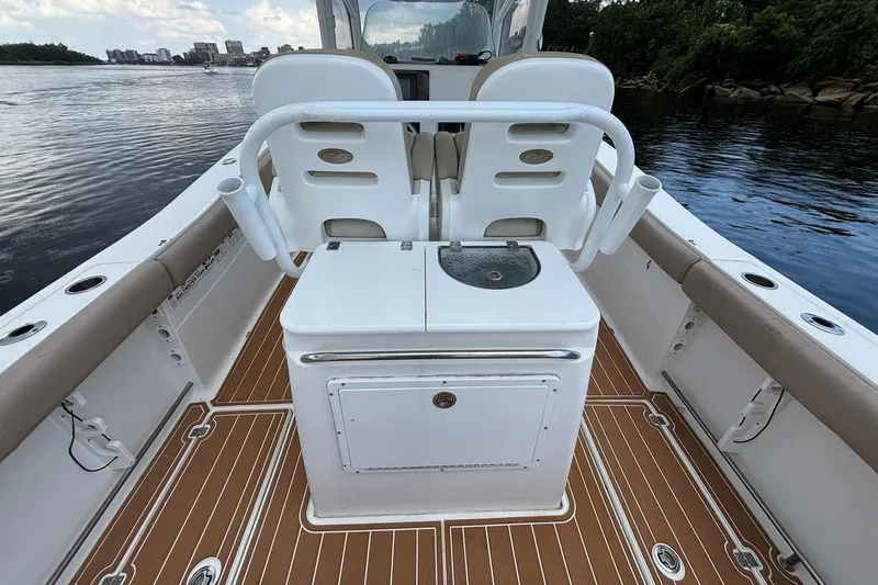 Slide: The Image of 2016 Sea Fox 286 boat interior with seating and storage, on calm water. - 27