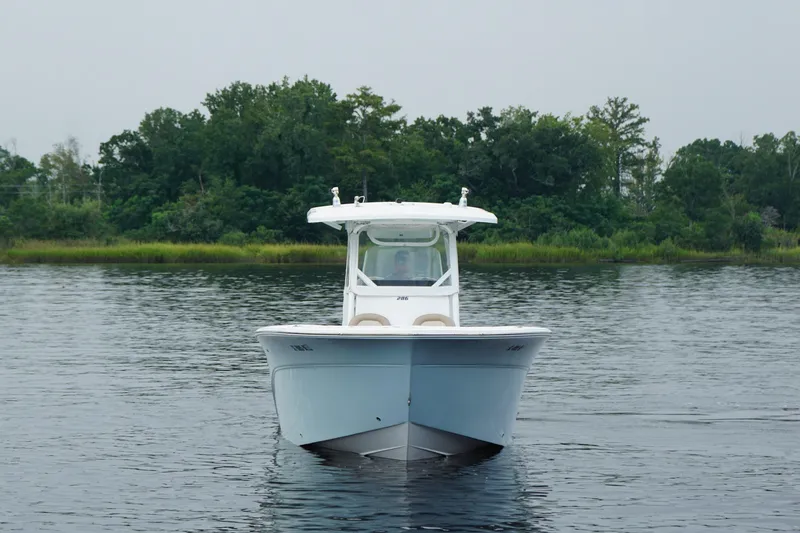 Slide: The Image of 2016 Sea Fox 286 boat on calm water with lush green background. - 3