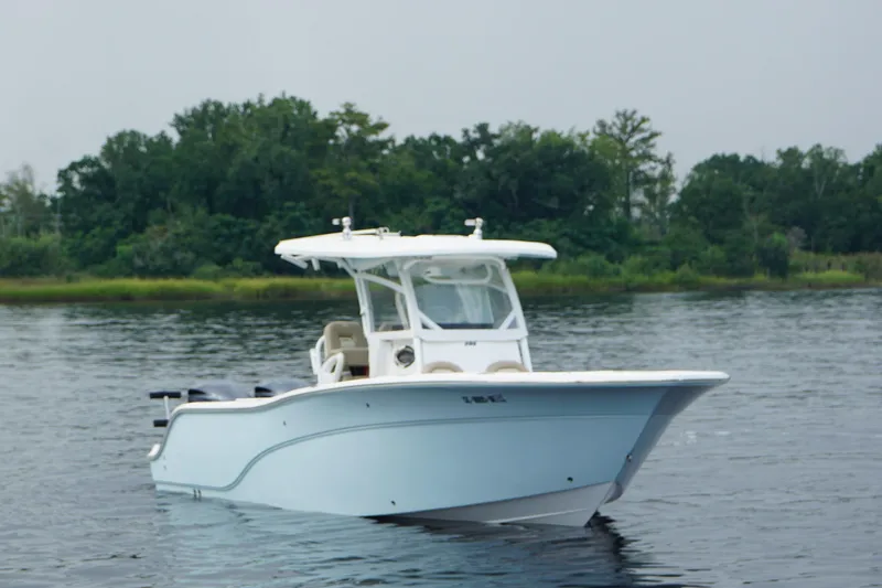 Slide: The Image of 2016 Sea Fox 286 boat on calm water with lush green background. - 4