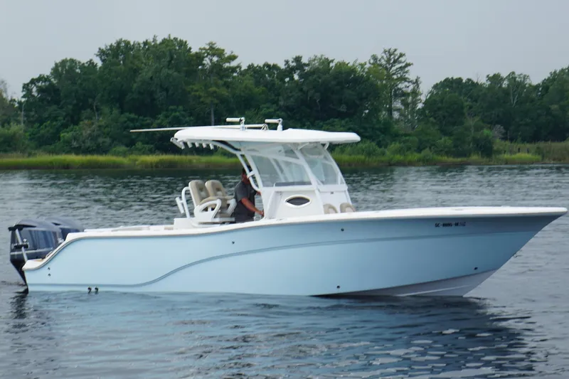 Slide: The Image of 2016 Sea Fox 286 boat on calm water with lush green background. - 6