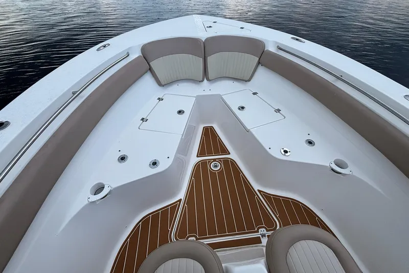 Slide: The Image of 2016 Sea Fox 286 boat interior with cushioned seating and wood-patterned flooring. - 7