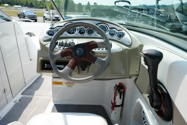 Slide: The Image of 2006 Crownline 252 EX boat dashboard with steering wheel and control panel. - 12