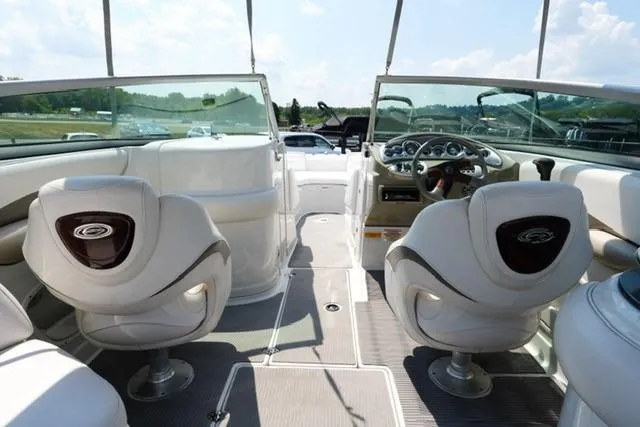 Slide: The Image of 2006 Crownline 252 EX boat interior with steering wheel and seating, showcasing luxury design. - 13