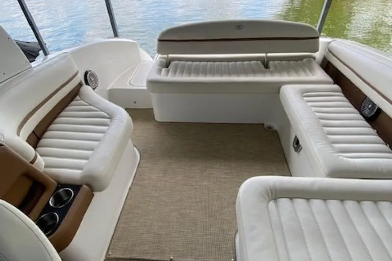 Slide: The Image of 2015 Cobalt R7 boat interior with white cushioned seating and lake view. - 11