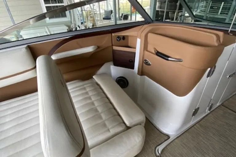 Slide: The Image of Interior of a 2015 Cobalt R7 boat with beige and white seating. - 8