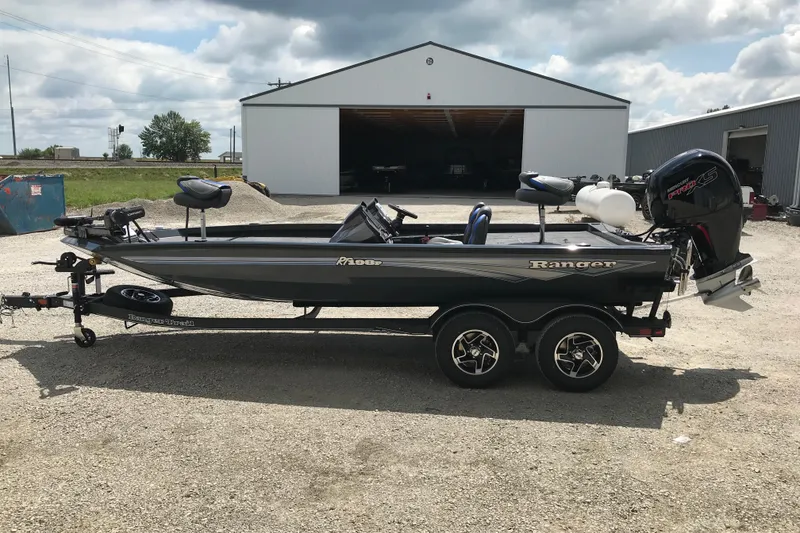 Slide: The Image of 2026 Ranger RT198P fishing boat on trailer, parked outside a building. - 2