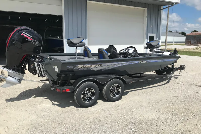 Slide: The Image of 2026 Ranger RT198P fishing boat on trailer, parked outside a building. - 6