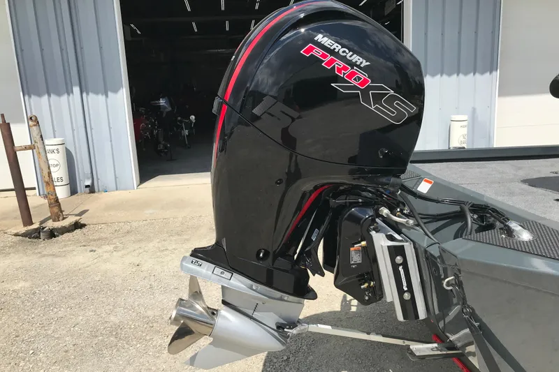 Slide: The Image of 2026 Ranger RT198P fishing boat with Mercury Pro XS engine, parked outside a garage. - 7