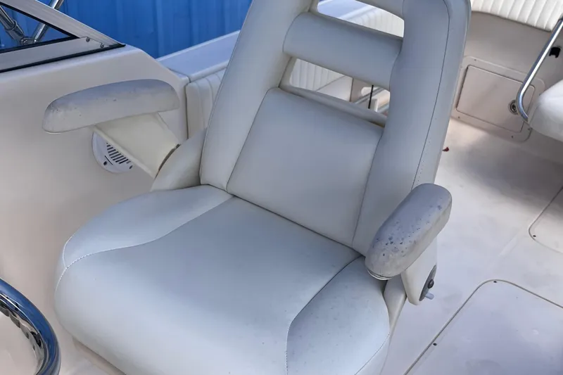Slide: The Image of 2006 Grady-White Tournament 225 boat seat with white upholstery and armrests. - 12