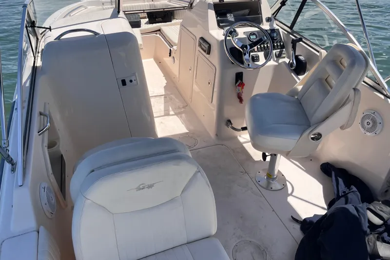 Slide: The Image of 2006 Grady-White Tournament 225 boat interior with steering wheel and seating. - 19