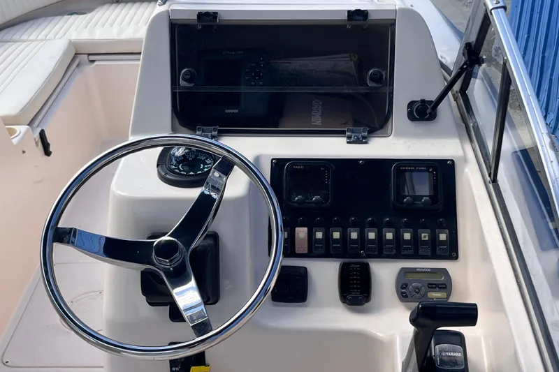 Slide: The Image of 2006 Grady-White Tournament 225 boat dashboard with steering wheel and control panel. - 6