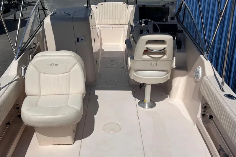 Slide: The Image of 2006 Grady-White Tournament 225 boat interior with white seating and steering console. - 8