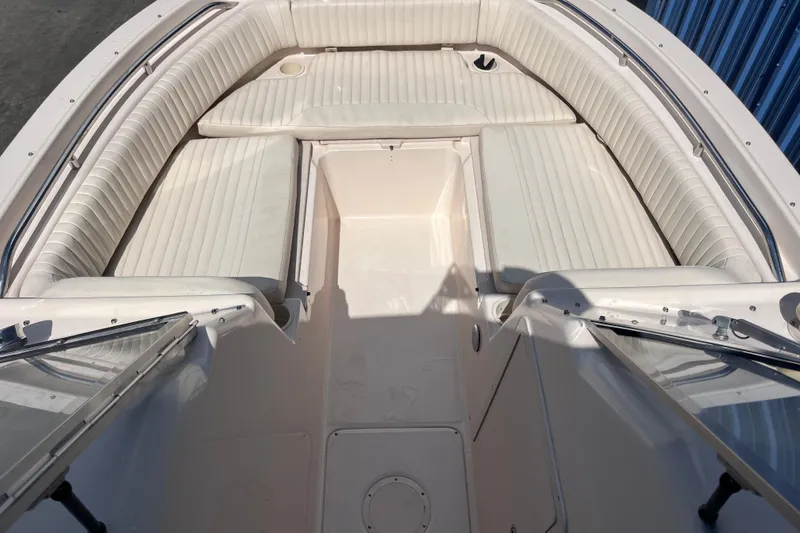 Slide: The Image of 2006 Grady-White Tournament 225 boat interior with white cushioned seating. - 9
