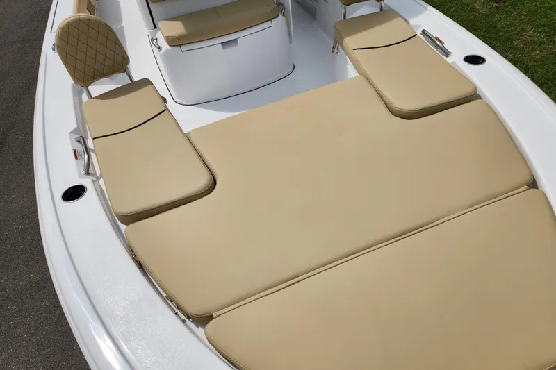 Slide: The Image of 2026 Sportsman Masters 247 Bay Boat with beige cushioned seating and sleek white deck. - 13